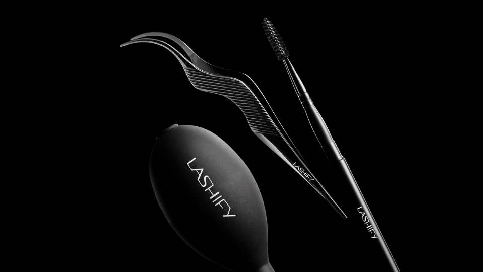 Flat lay of Lashify lash accessories including the Control Kit, wand and lash comb