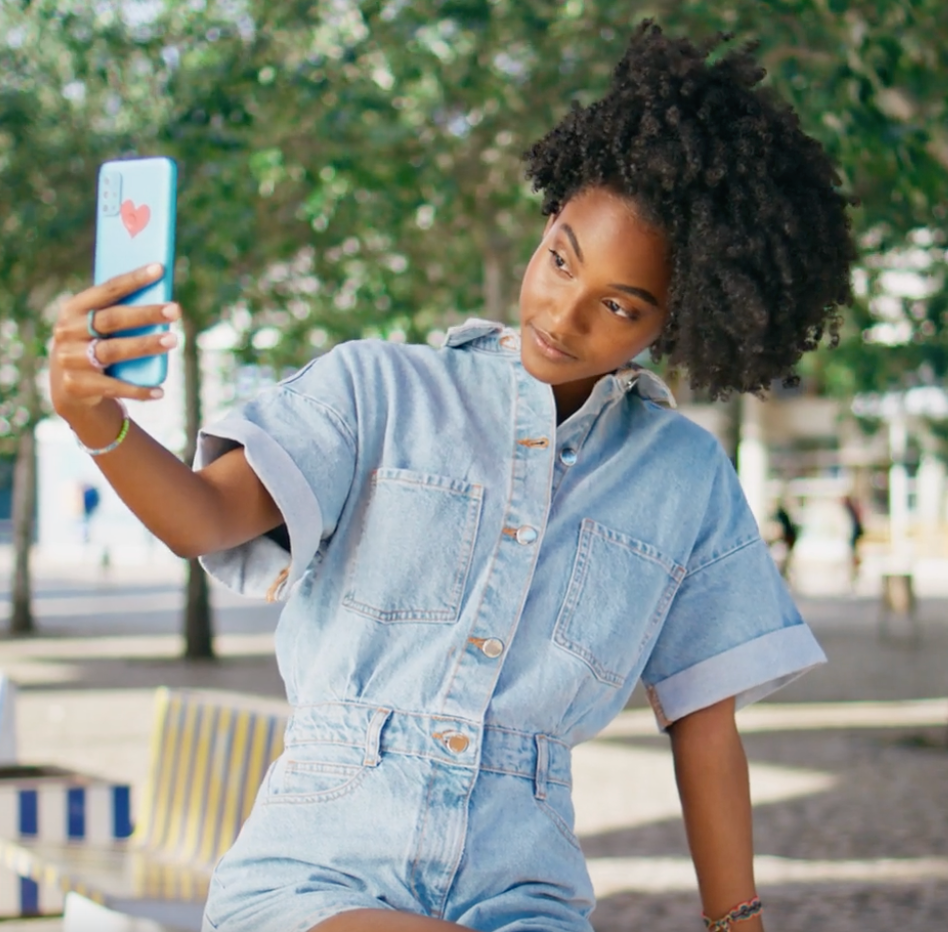Lashify content creator taking a selfie outside, embracing natural beauty and confidence